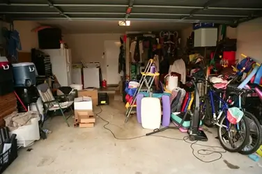 Cluttered garage before Tommy's Junk Removal.